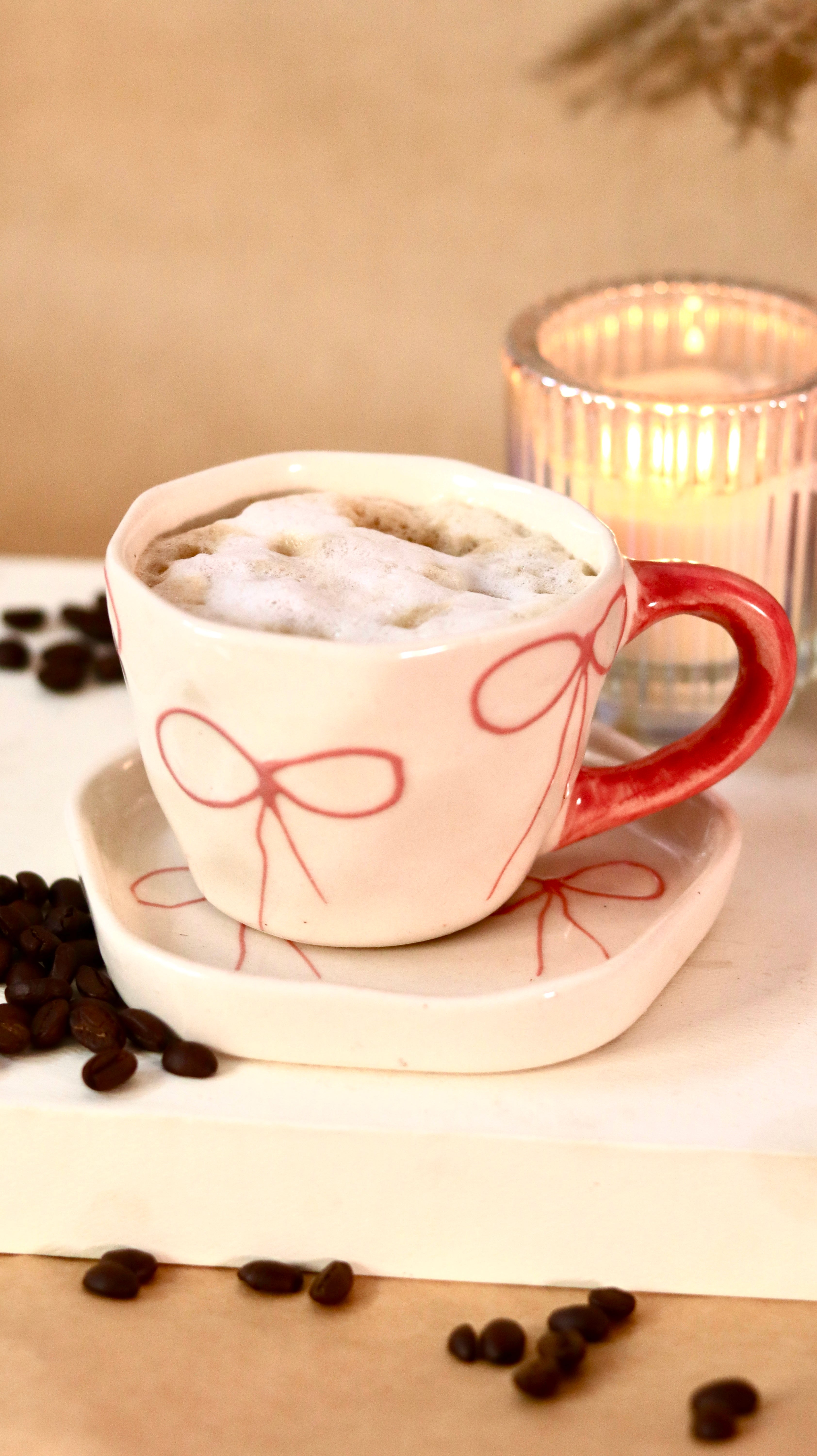 À La Bow ceramic cup and saucer set with delicate bow detail and soft blush finish by KLAEORA