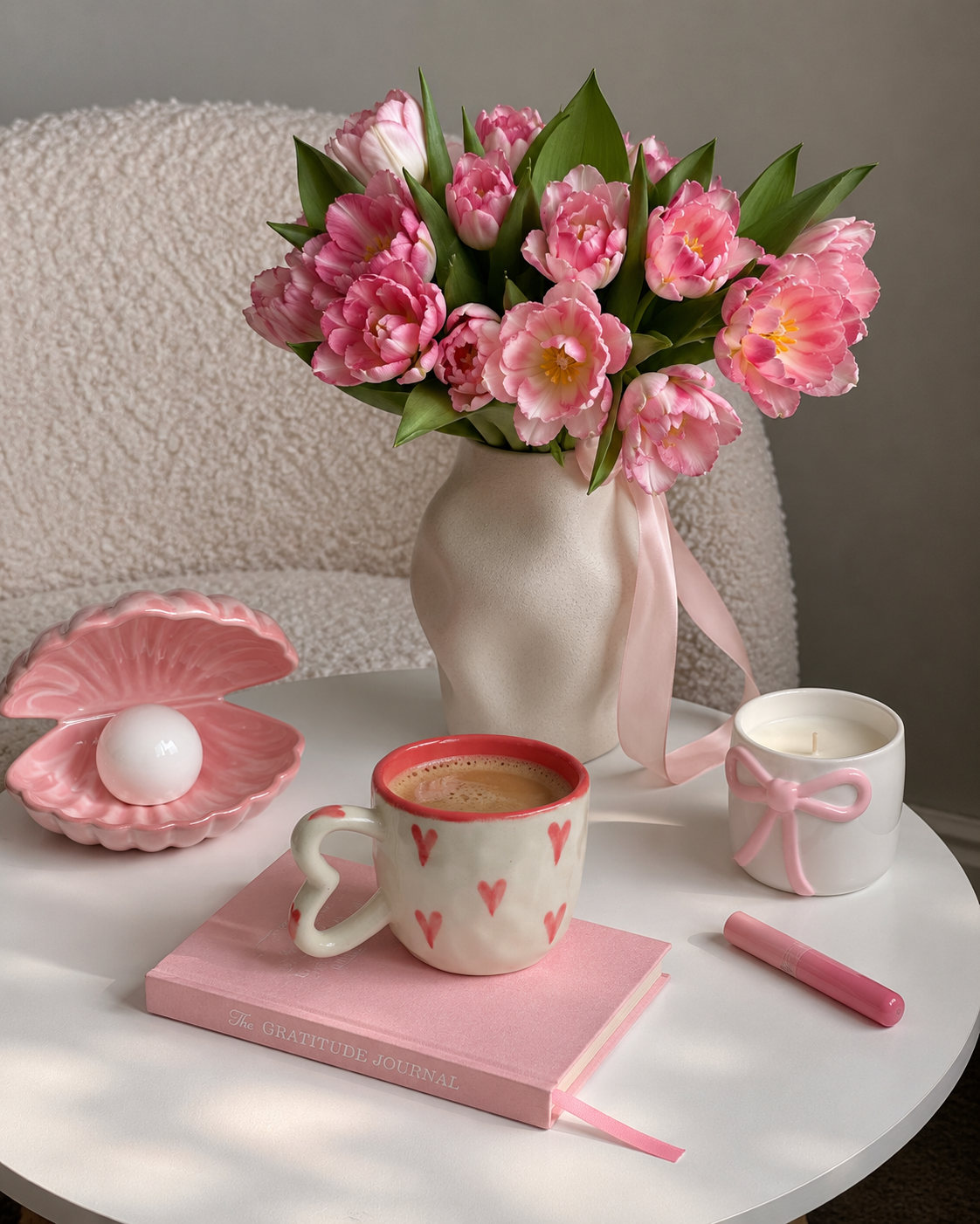 a white mug with pink heart patterns and a heart-shaped handle