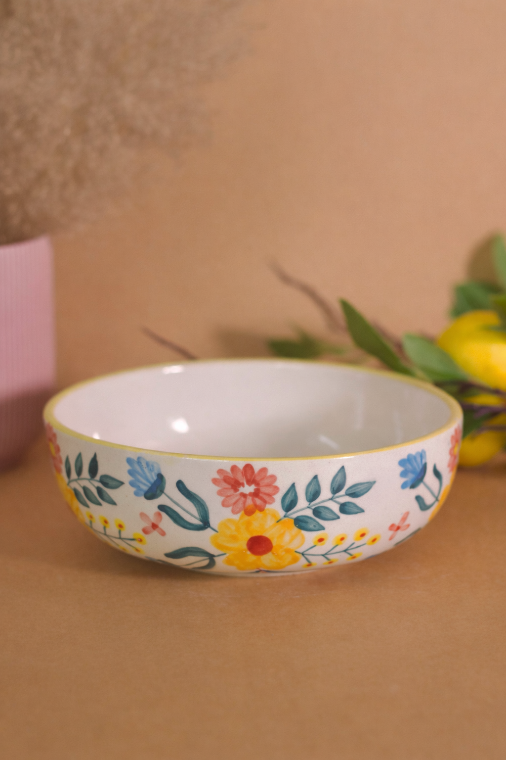 Decorative ceramic bowl with floral patterns on a brown surface
