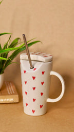 White ceramic sippper  with red heart and straw