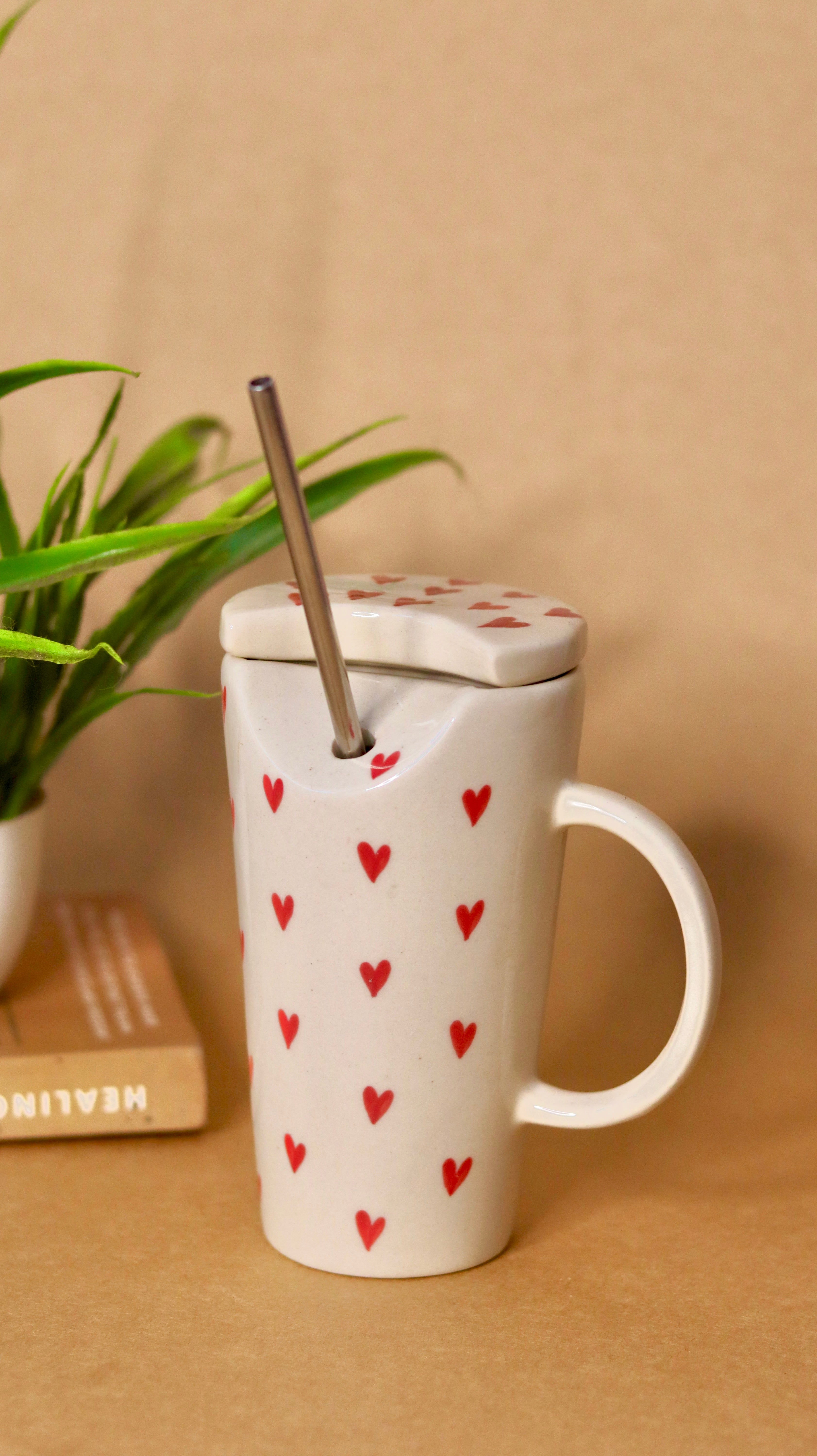 White ceramic sippper  with red heart and straw