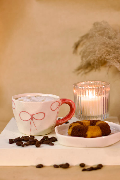 À La Bow ceramic cup and saucer set with delicate bow detail and soft blush finish by KLAEORA