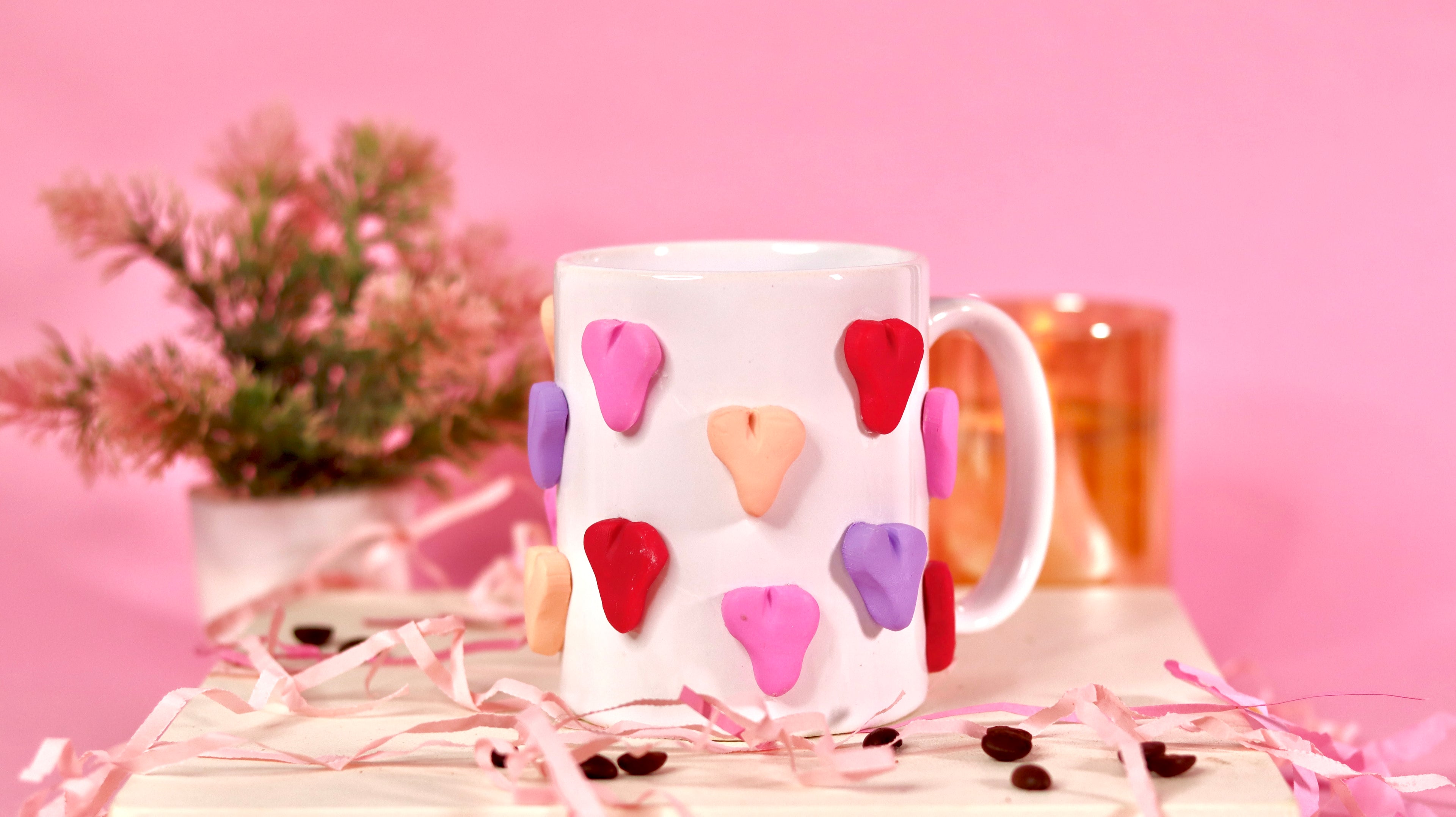 white ceramic mug with 3d colourful heart.
