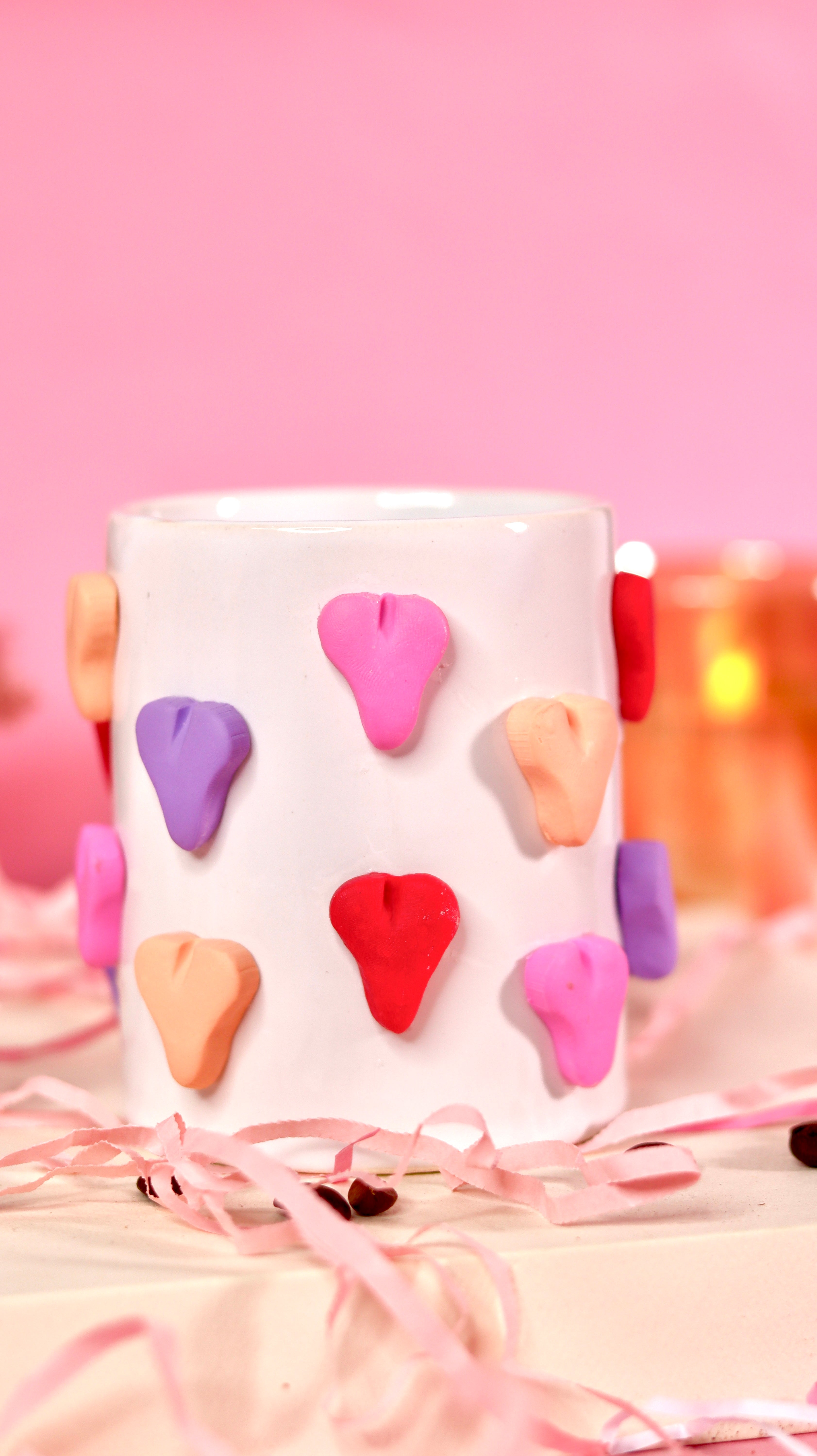 white ceramic mug with 3d colourful heart.
